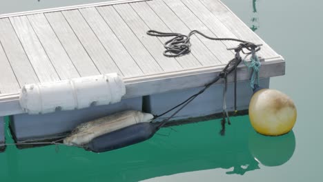 a shot of a small dock moving slowly in quiet water