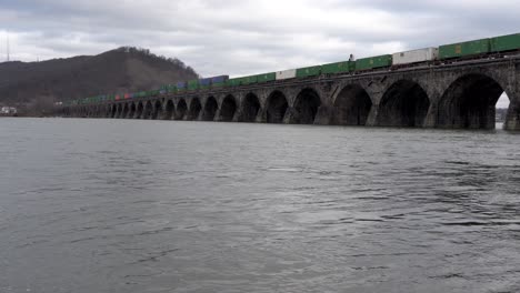 harrisburg, pennsylvania - january 7, 2021: train crossing a stone bridge over the susquehanna river near harrisburg, pennsylvania