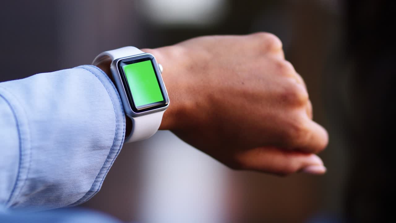 Close up of a woman checking a smartwatch, green screen