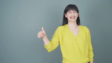 the woman promoting is pointing to the side and laughing.