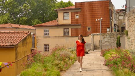 Portrait-Of-A-Female-Tourist-Walking-On-The-Old-Village-Street-In-Porto,-Portugal