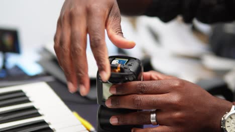 Man-repairing-the-camera-flash-by-replacing-the-bottom