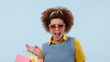 cara, gafas de sol y bolsas de compras de mujer