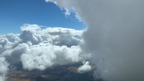 nice aerial view from a jet cockpit leaving by the right a cumuloninbus cloud during the descent to seville airport