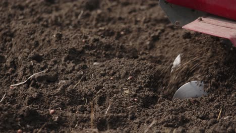 electric rotary tiller cultivating soil detailed shot