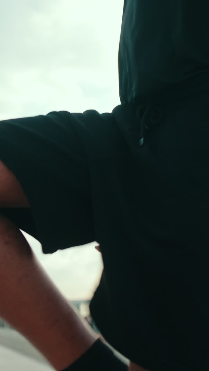 Young Man Warming Up Before a Run by The Harbor