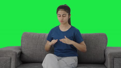 Indian-teenage-girl-doing-breathe-in-breathe-out-exercise-Green-screen