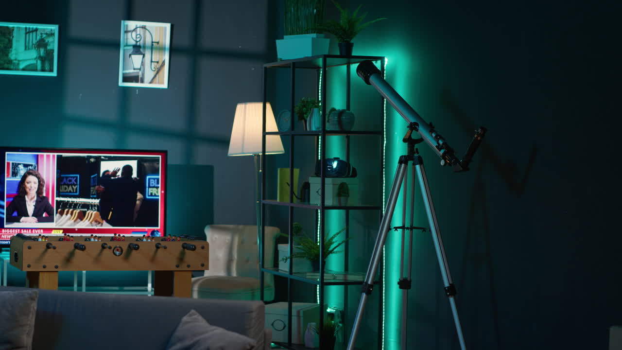 Modern high end studio apartment with neon lights and trendy decorations, stylish comfortable living space with a coffee table and smart tv setup for a home theatre. Contemporary room.