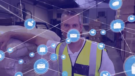 Animation-of-network-of-digital-icons-against-caucasian-male-worker-smiling-at-warehouse