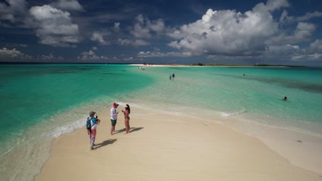 paradise found: beach bliss, woman film couple lovers at beach paradise, aerial view