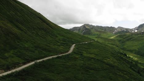 roadtrip in alaska, sunset and the open road, what a view, following a car down a road from a drone