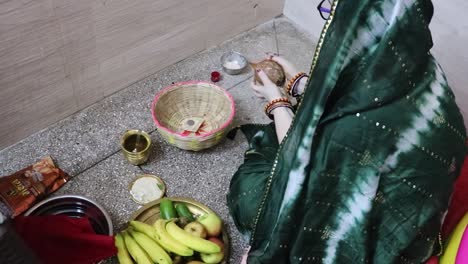 indian women doing holy rituals at home for children's wellbeing from different angle on the occasion of jitiya vrat or nirjala vrat in india