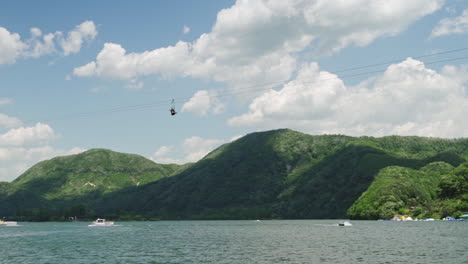nami skyline zipwire ziprider zip line over the han river as seen from a nami island ferry, wide track in slow motion.