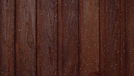 animation of winter scenery with snow falling over wooden boards