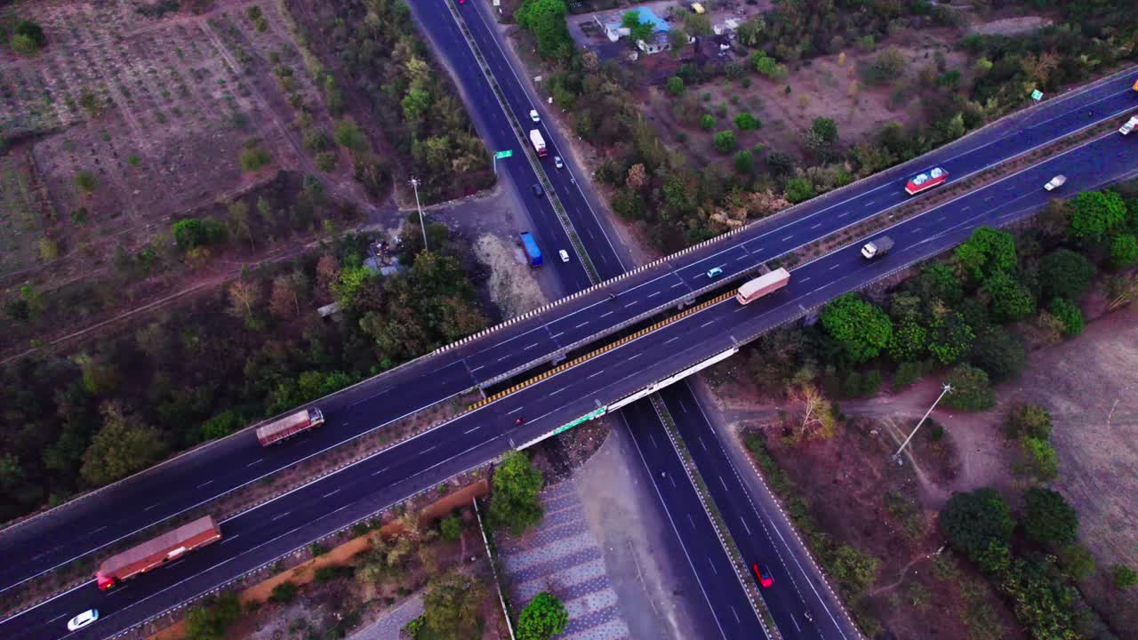Interchange Bridge or outer ring road with trees and vehicles at Jamtha, Nagpur, Maharashtra, india. day time, push in, Tilt down, drone shot, 4k.
