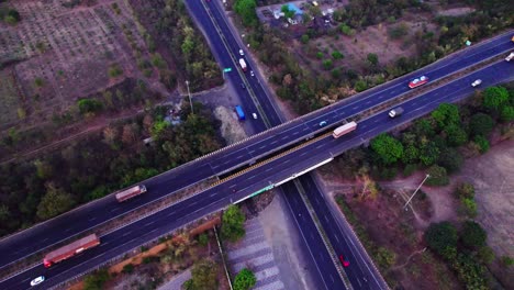interchange bridge or outer ring road with trees and vehicles at jamtha, nagpur, maharashtra, india. day time, push in, tilt down, drone shot, 4k.