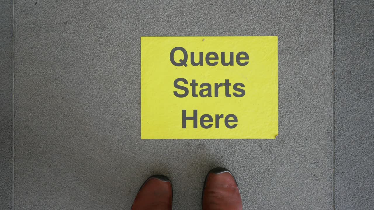 Queue Starts Here Sign on Floor