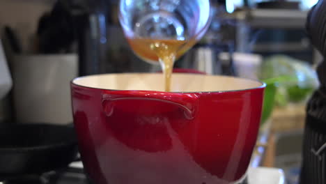 Adding-chicken-broth-stock-to-a-homemade-recipe---slow-motion