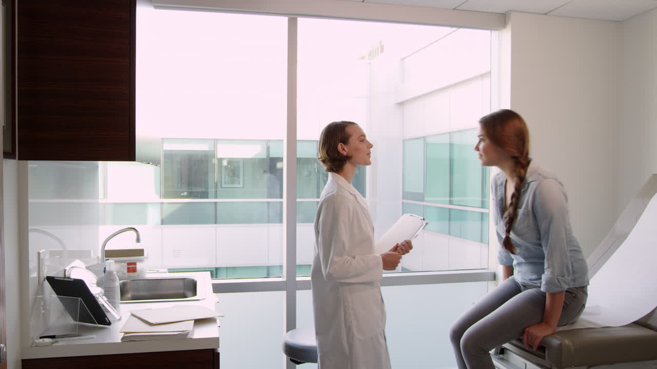 Doctor Meets With Teenage Patient In Exam Room Shot On R3D