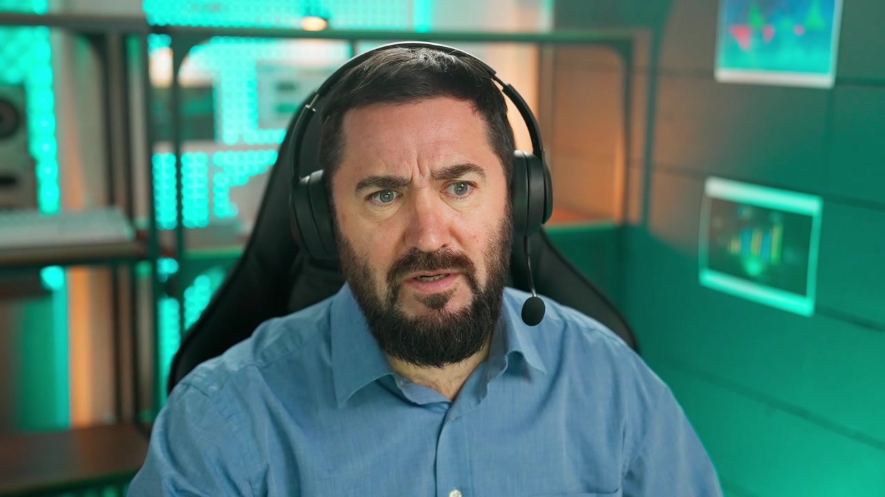 Skäggig man med headset pratar och ler under ett online videosamtal