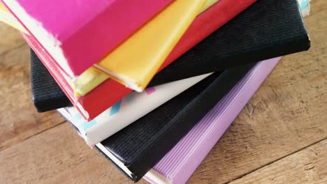 Back-to-school-text-against-stack-of-books-on-wooden-table