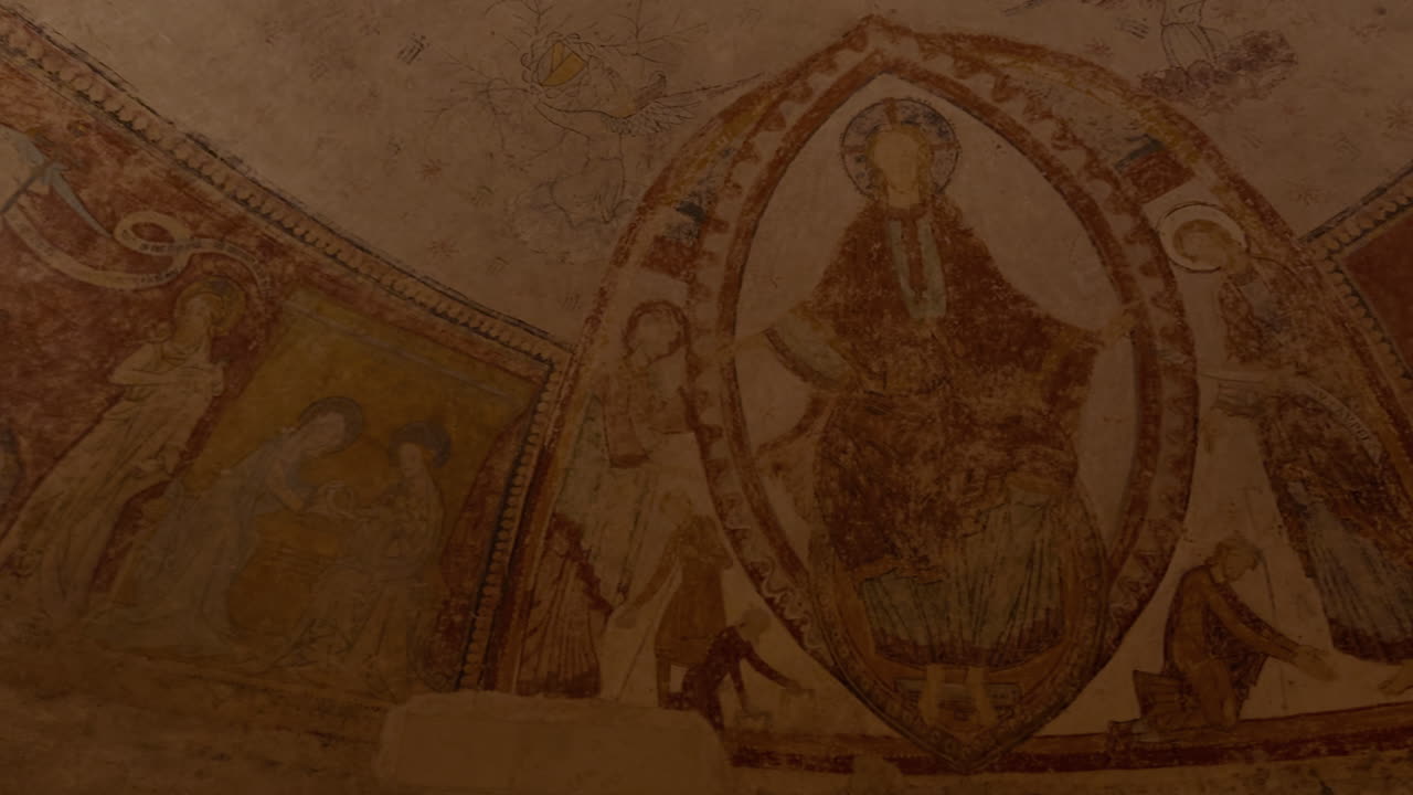 Ancient frescoes in the medieval crypt of Saint-Aignan, France, depicting religious art