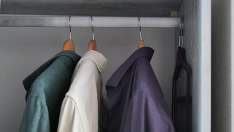 a closet with shirts hanging on hangers