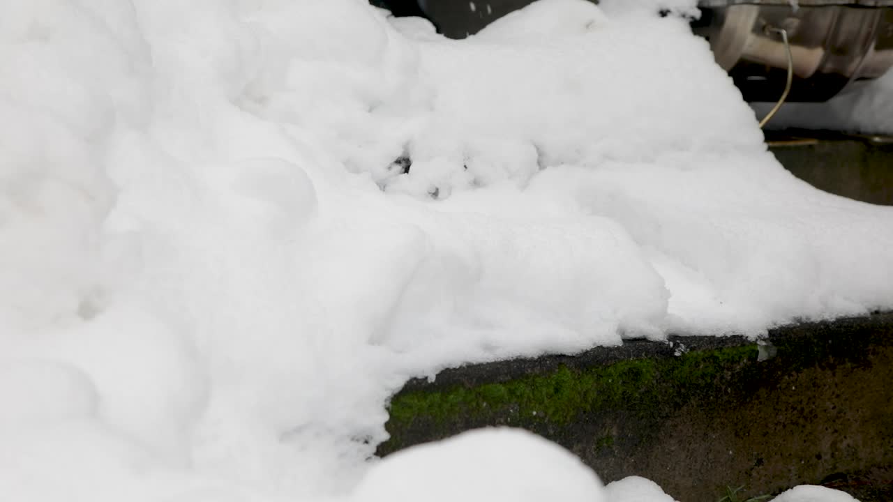 Close up of person climbing snowy stairs after snowstorm in winter