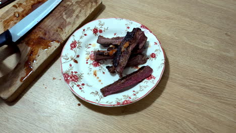 Food-preparing-of-delicious-roasted-sliced-beef-on-a-traditional-plate