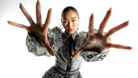 fashion model posing with hands in slow motion on white background