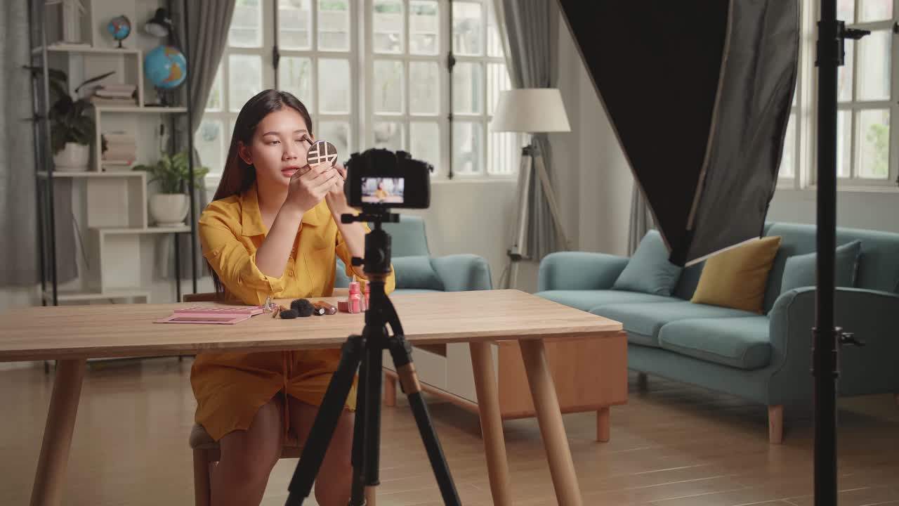 Blogging, Technology, Videoblog, Makeup And People Concept, Beauty Blogger With Eye Shadow Brush And Camera Recording Makeup Tutorial Video At Home