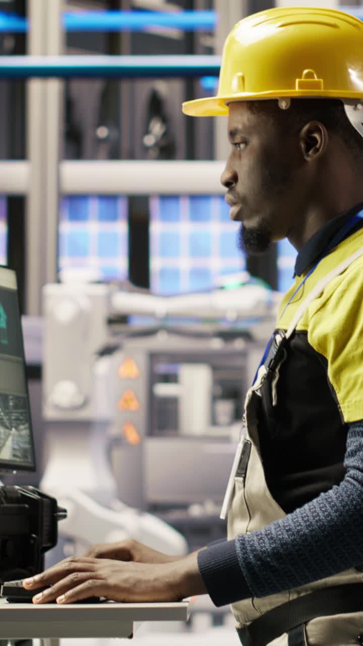 Vertical video Engineer overseeing solar panel production lines equipment using PC software