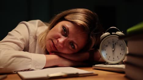 exhausted woman working late at desk