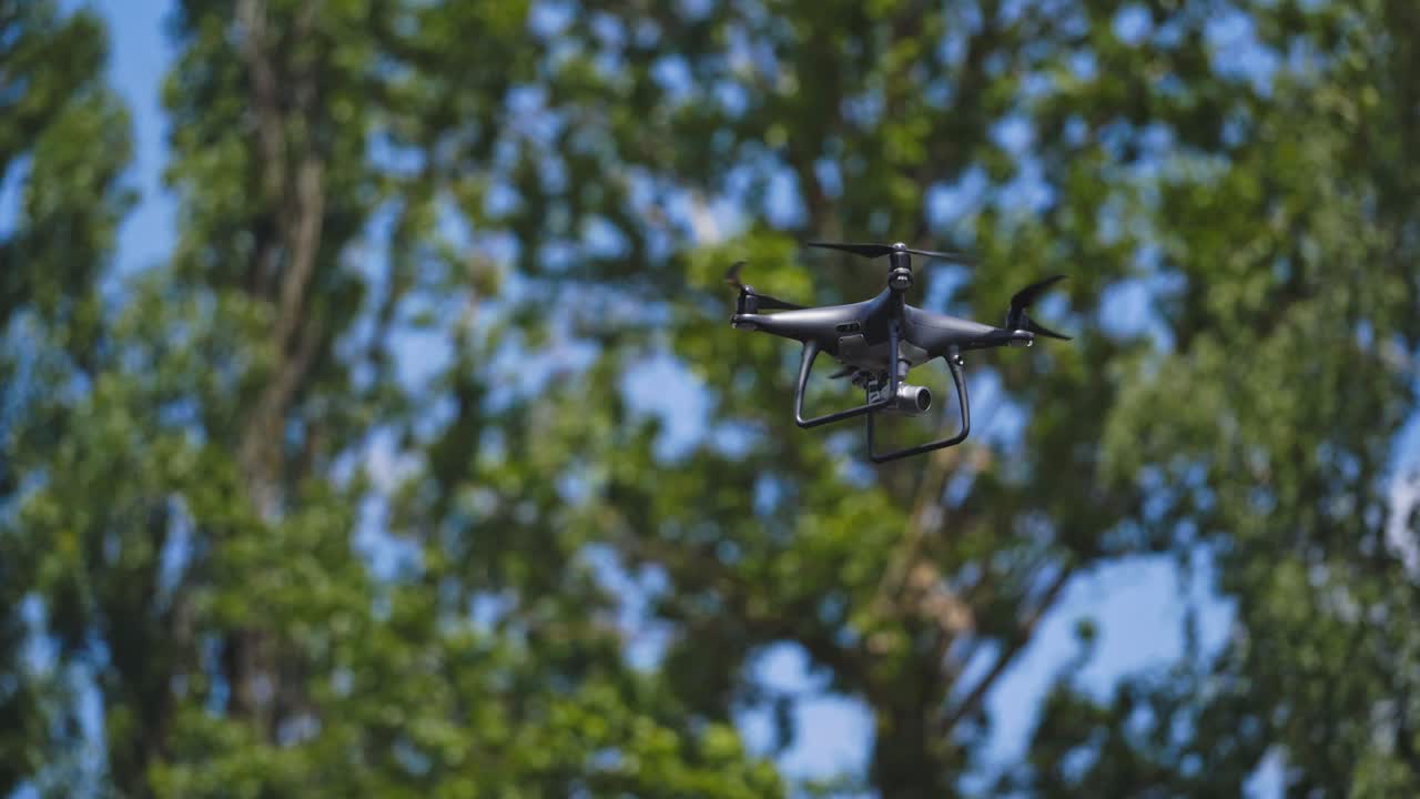 Electric drones flies in the sky. Quadcopter with camera flying in sky