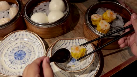 savoring dumplings with chopsticks at a table