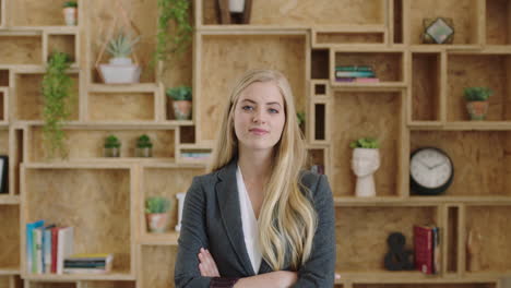 portrait of attractive young blonde business executive arms crossed smiling confident successful independend woman