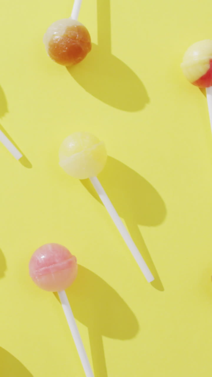 video de piruletas multicolores sobre un fondo amarillo