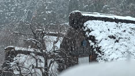 a serene snowfall blankets the unesco world heritage village of shirakawa-go, japan.