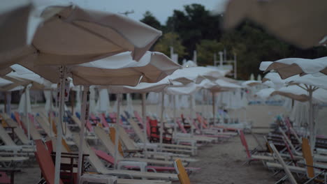 Empty-chaise-longues-on-resort-in-cloudy-windy-evening