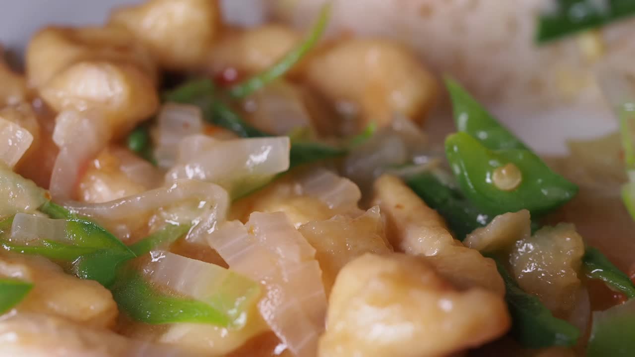 Close-up of Stir-fried Chicken or Fish with Green Peppers and Onions