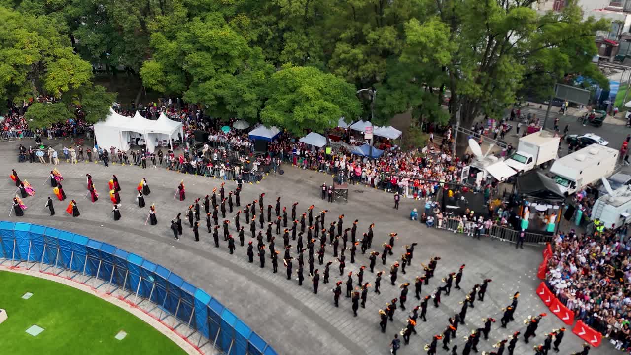 Aerial shot of a marching band participating in the Day of the Dead festival in Mexico City