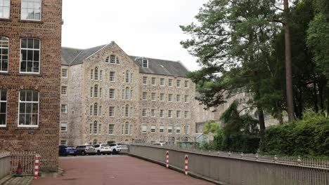 revealing shot of the busy tourists spot at the New Lanark Mill Hotel