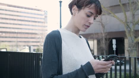 아름다운 젊은 여성이 전화로 문자 메시지를 보내는 낮은 각도 뷰