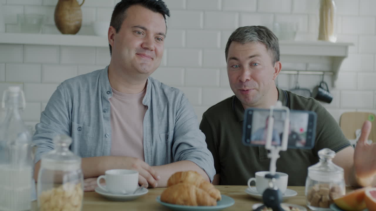 Two Men Having a Video Call Over Breakfast