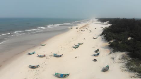 Local-Trung-Thanh-Beach-at-Vietnam-with-fishing-boats-on-shore,-aerial