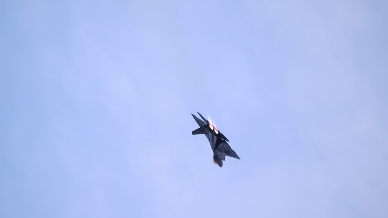 F-22 Performs Aileron Roll with Afterburner Exhaust Flame SLOMO BEHIND