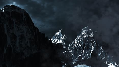 stormy snowy mountain peaks at night