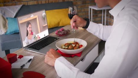 caucasian couple making valentines date video call man eating meal woman on laptop screen