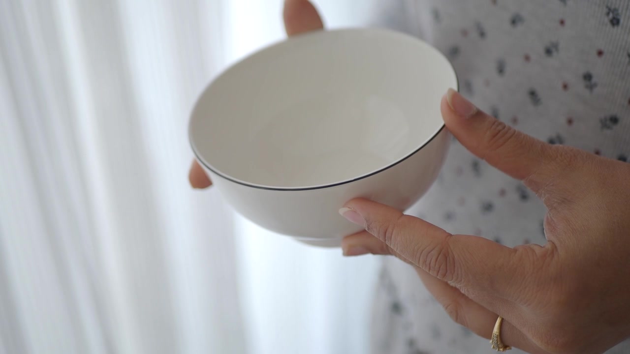 Close-up of Hands Holding an Empty White Ceramic Bowl