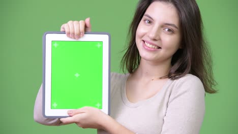 young happy beautiful woman smiling while showing digital tablet